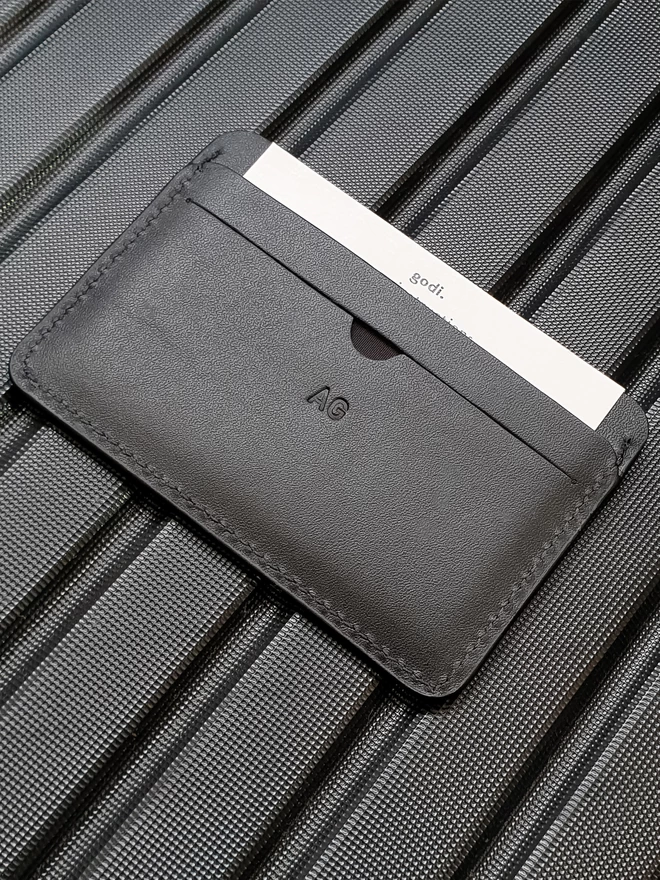 Image of personalising on Card Case. The initials are AG embossed on