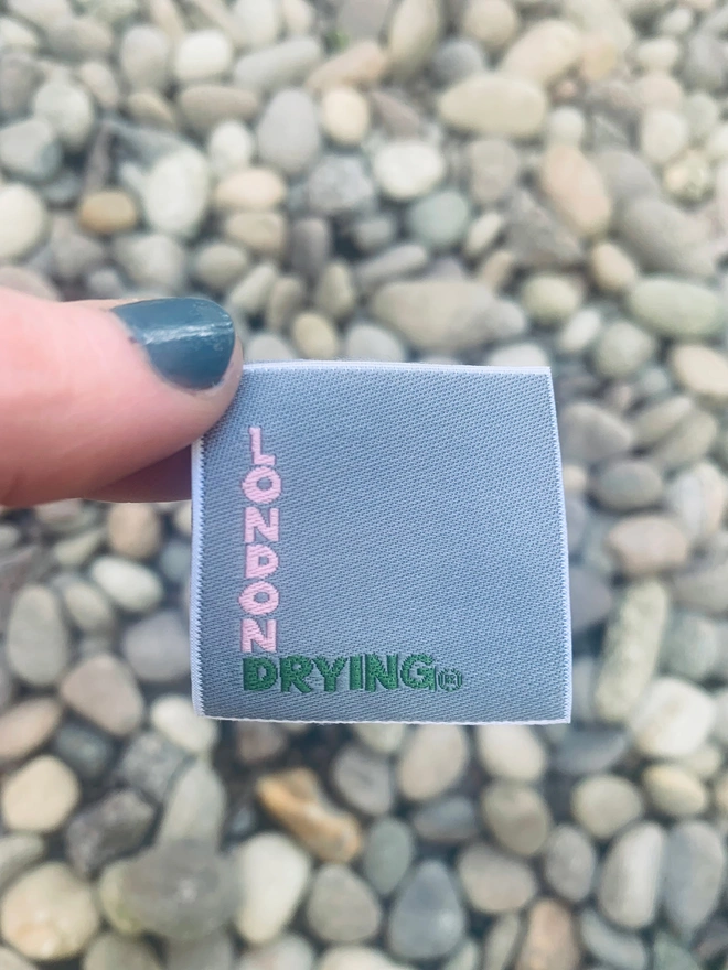 London Drying brand label held above gravel