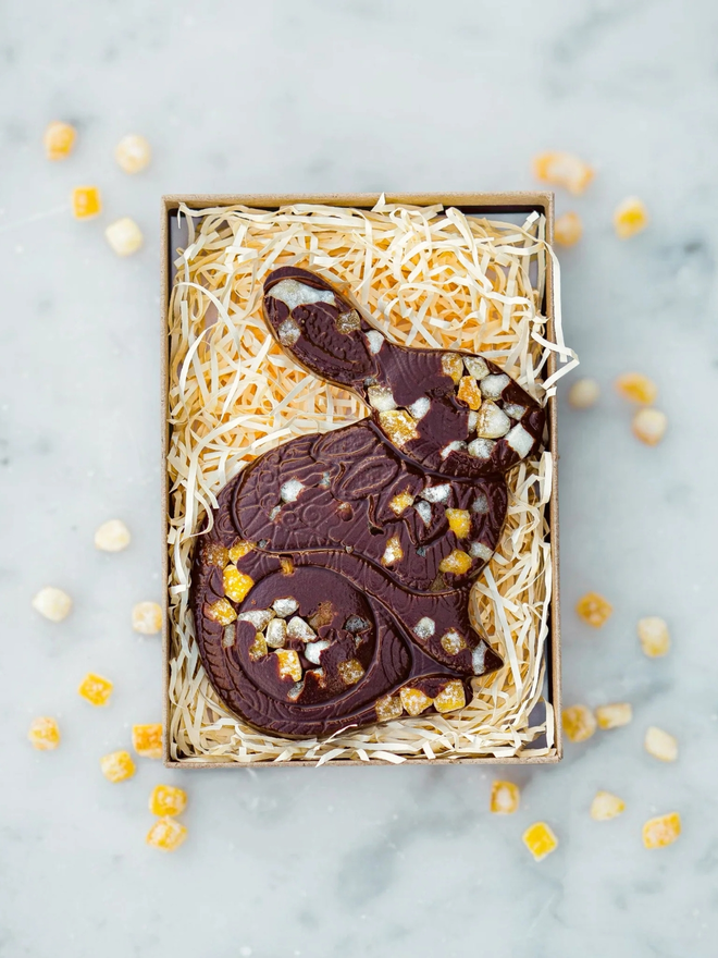 Sicilian Orange Vegan Chocolate Luigi Bunny in a box of straw with orange scattered around