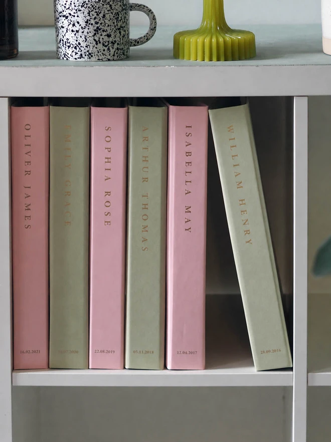 personalised keepsake ring binder. a collection of ring binders with personalised names on the spine with a date a the bottom