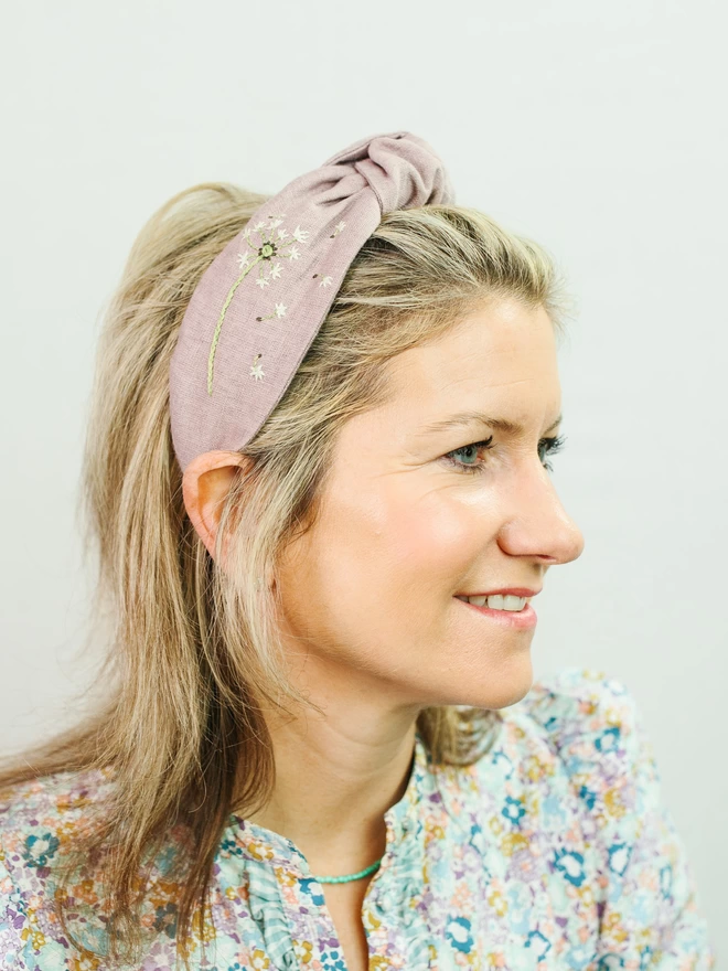 woman wearing embroidered hairband in lilac in linen