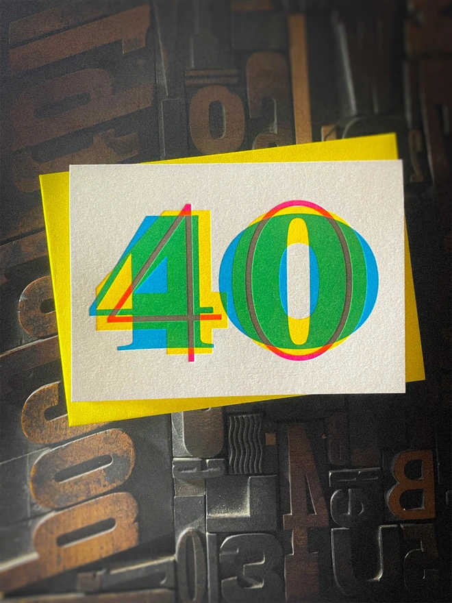 Contemporary handmade letterpress 40th birthday card featuring a bold oversized "50" in a vibrant typographic design. Printed using overlapping cyan, magenta and yellow inks to create striking secondary colours with a deep tactile letterpress impression. Individually hand printed on premium 350gsm GF Smith Colorplan card and paired with a high-quality 135gsm GF Smith Colorplan envelope in a complementary colour. Produced on a beautifully restored 1915 Arab Crown Folio press.