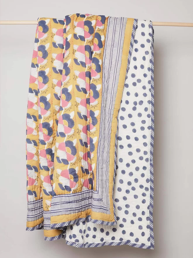 Hanging block printed yellow floral quilt