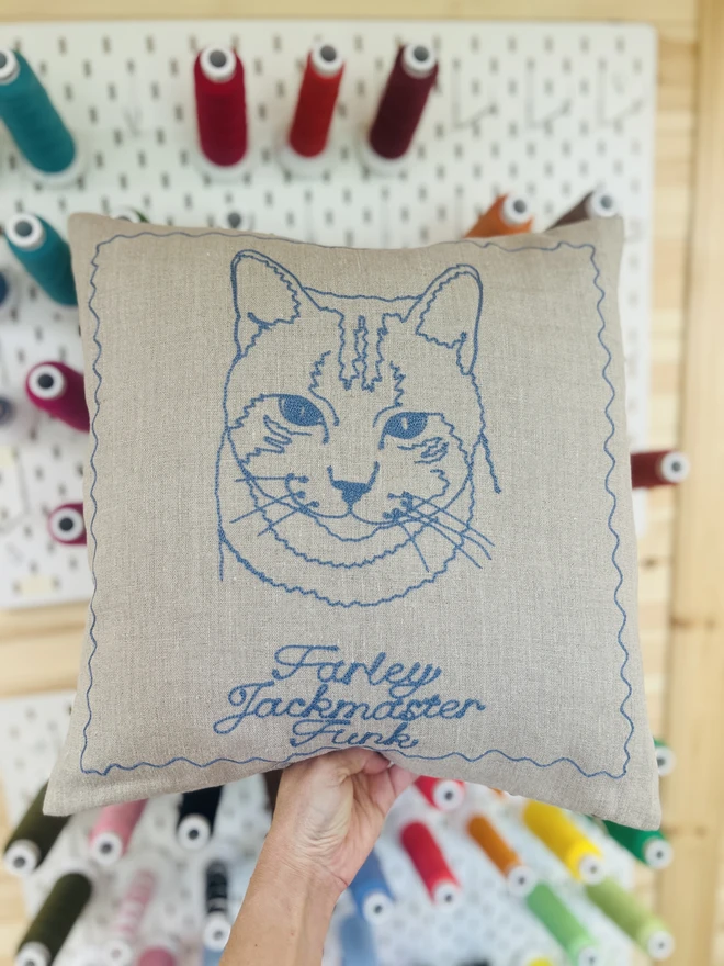 linen pillow with embroidered cat in dusty blue thread