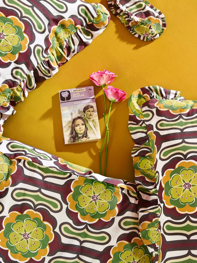 Thelma Pillowcases. Green, brown, white, and black retro-patterned pillowcases.