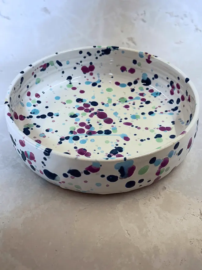 Sweetpea Pasta Bowl, a colourful bowl on a stone surface. 