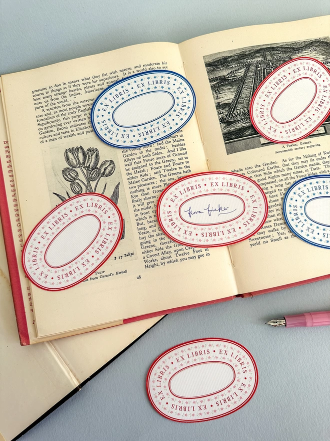 Floral Ex Libris Book Plate Self Adhesive Label, perfect gift for book lovers, avid readers, or to personalise your home library. In blue or red. Designed by Flora Fricker, graphic designer. Photographed in vintage book.