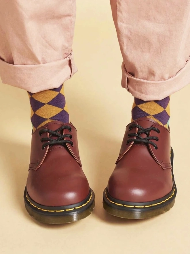 Women's Organic Cotton Ankle Socks Packs (Sets Of 3), a person wearing a pair of colourful patterned socks. 