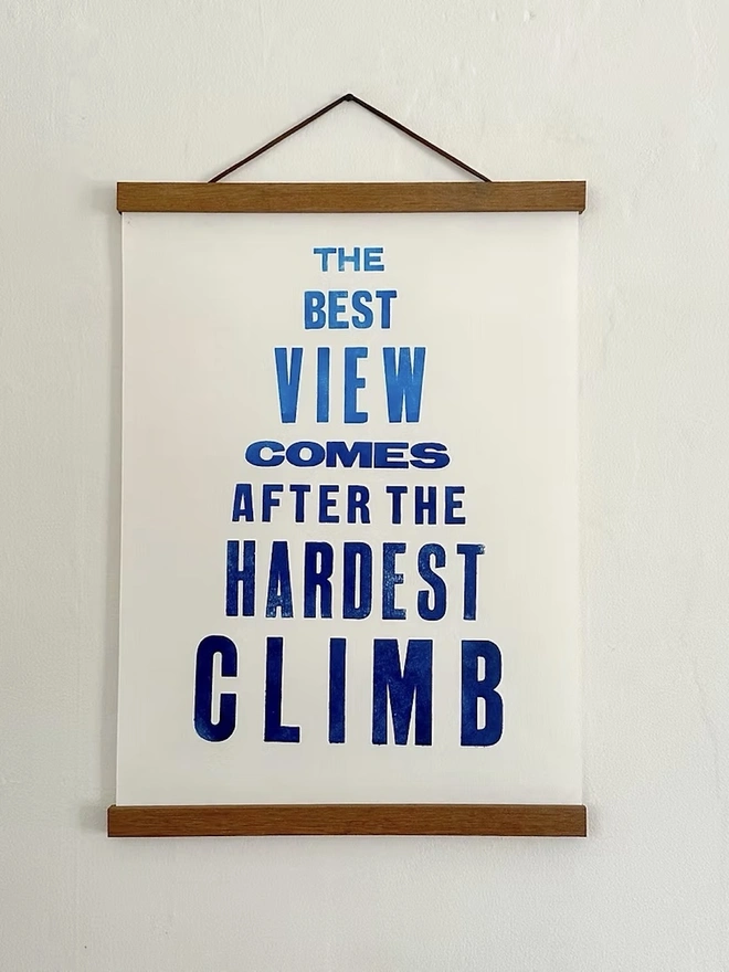 'The Best View Comes After The Hardest Climb' Print, framed and hung on a wall. 