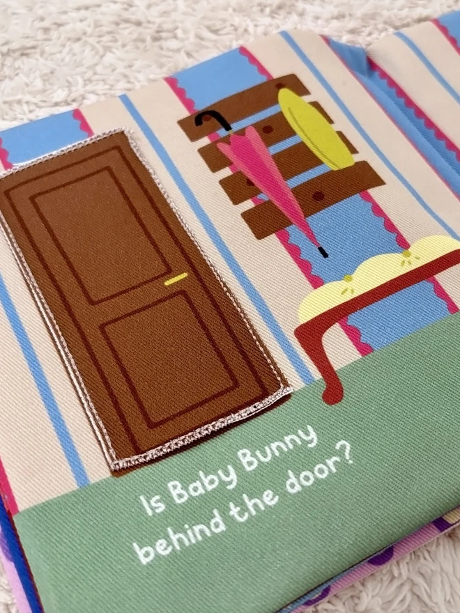 Page of Where's Baby Bunny? Lift-the-flap Cotton Soft Book, showing a door to lift