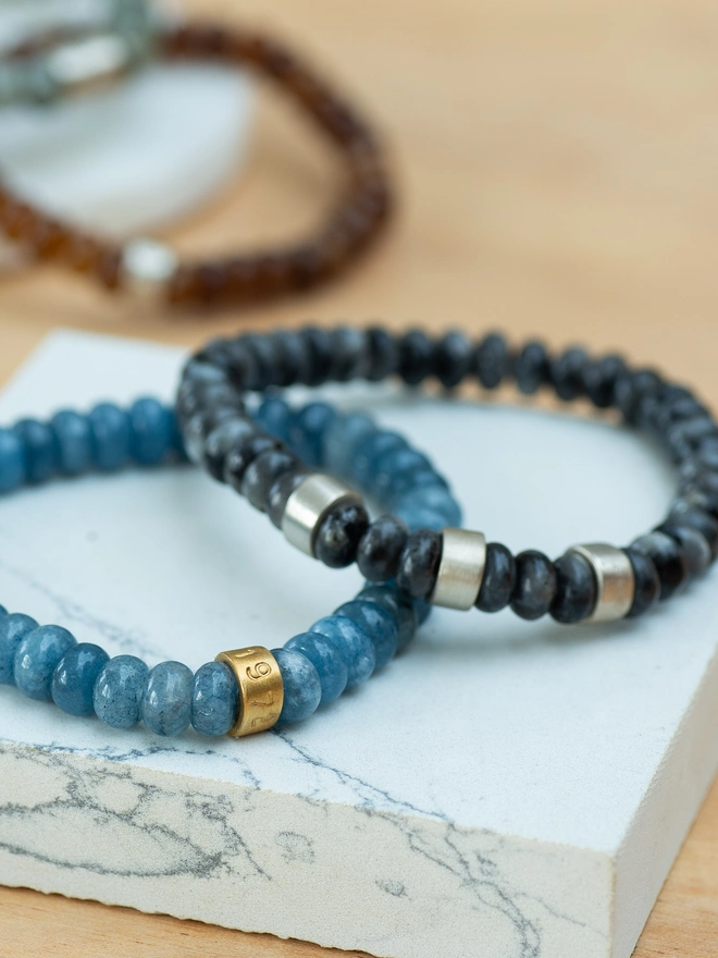 The Nomad Bracelet is crafted from natural jade and labradorite beads, strung on durable stretch elastic for effortless everyday wear. Finished with personalised sterling silver life beads, this meaningful beaded bracelet carries your story wherever you go. Strong, stylish and versatile, it’s the perfect personalised bracelet for dads, partners, brothers or friends — designed for life’s journeys.