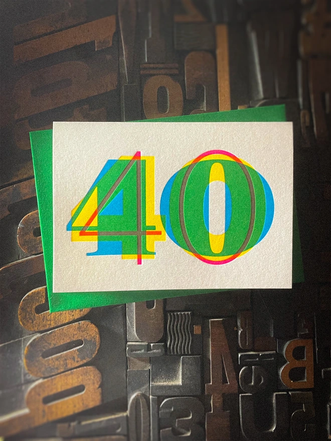 Contemporary handmade letterpress 40th birthday card featuring a bold oversized "50" in a vibrant typographic design. Printed using overlapping cyan, magenta and yellow inks to create striking secondary colours with a deep tactile letterpress impression. Individually hand printed on premium 350gsm GF Smith Colorplan card and paired with a high-quality 135gsm GF Smith Colorplan envelope in a complementary colour. Produced on a beautifully restored 1915 Arab Crown Folio press.