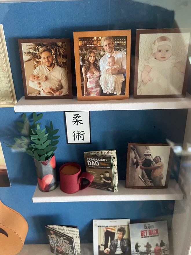 a wooden box with miniatures of the person favourite things inside. Each piece is handmade specially on request. bespoke art piece made by My Papercut Forest