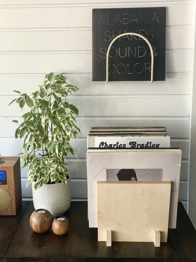 flip styled with records and plant and candles on a side board