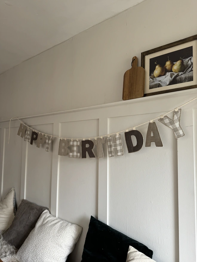 Linen Happy Birthday Garland. Fabric letters hung on a wall saying Happy Birthday