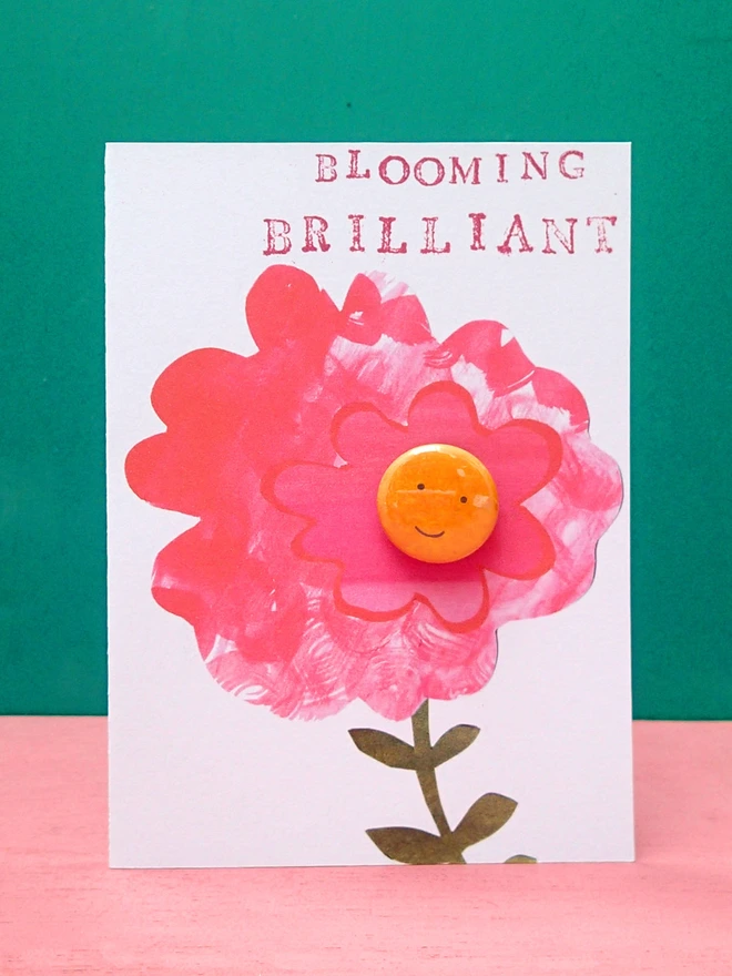 brilliant pink flower greeting card with happy face pin badge