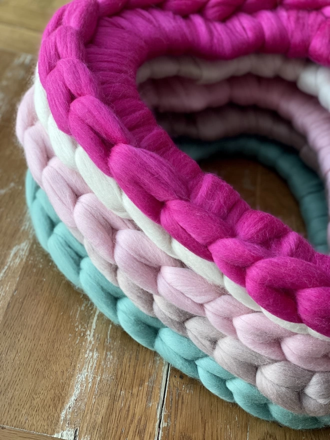 a stack of merino woolly heart wreaths