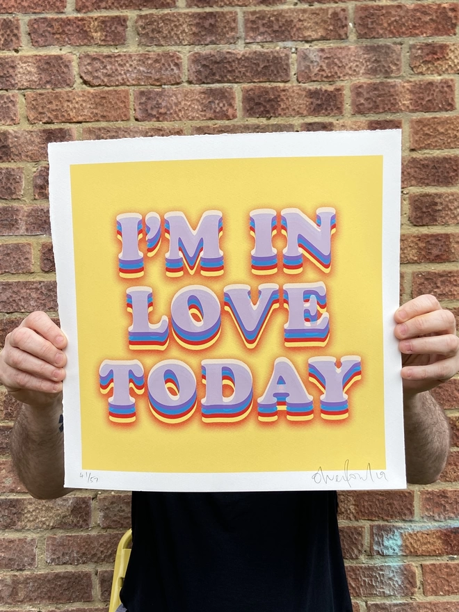 "I'm In Love Today" Hand Pulled Screen Print with deckled edges yellow background and the words I’m in love today printed on top in white with rainbow shading 