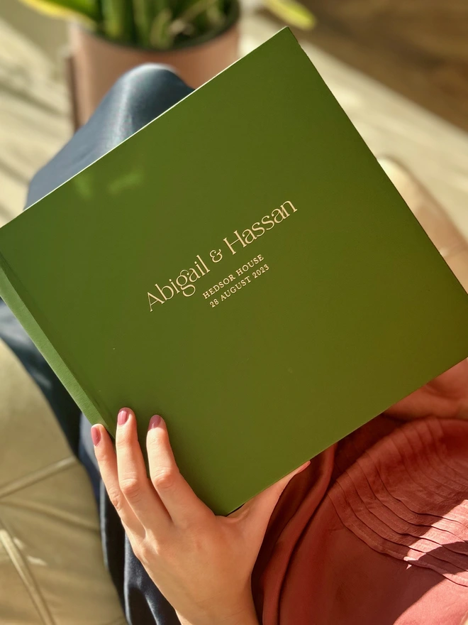 Large Wedding Photo Album Personalised With Bespoke Printing held by a woman.