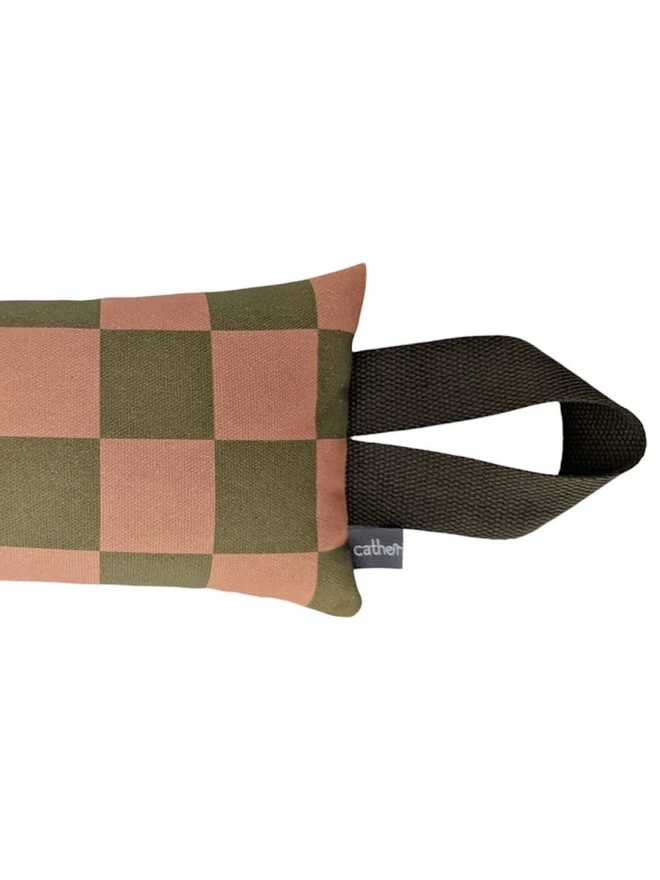 Draught Excluder, a colourful patterned draught excluder sitting on a white surface. 