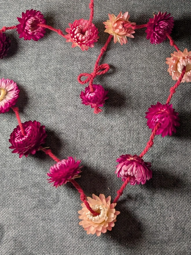Pink and red flower garland in a heart shape 