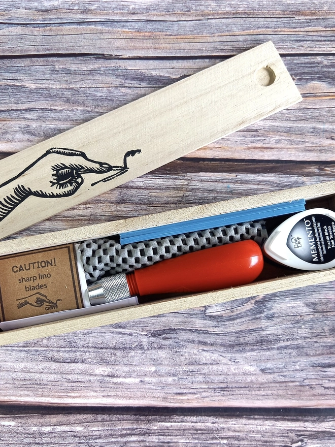 Lino Carving Printing Tool Kit In Presentation Box, packed together in a wooden box on a table. 