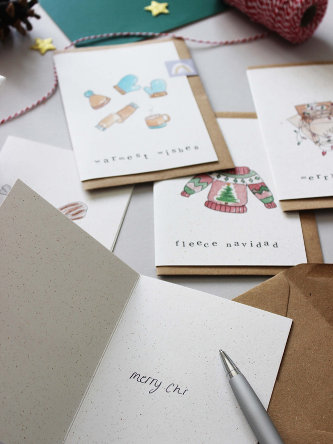 'An Eco-Friendly Christmas' Punny Card 5 Pack being written in