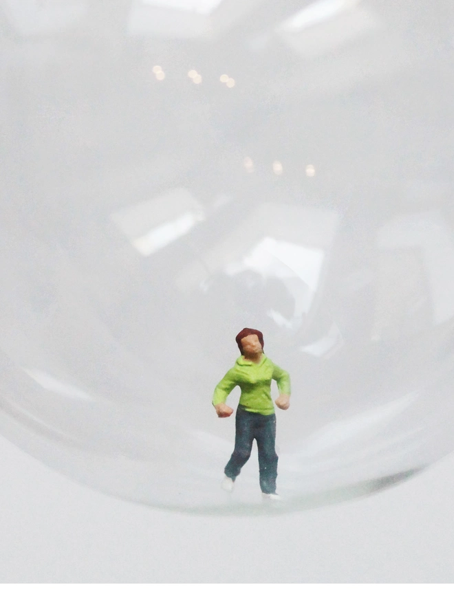 Miniature figure of a female runnerin a glass Christmas bauble
