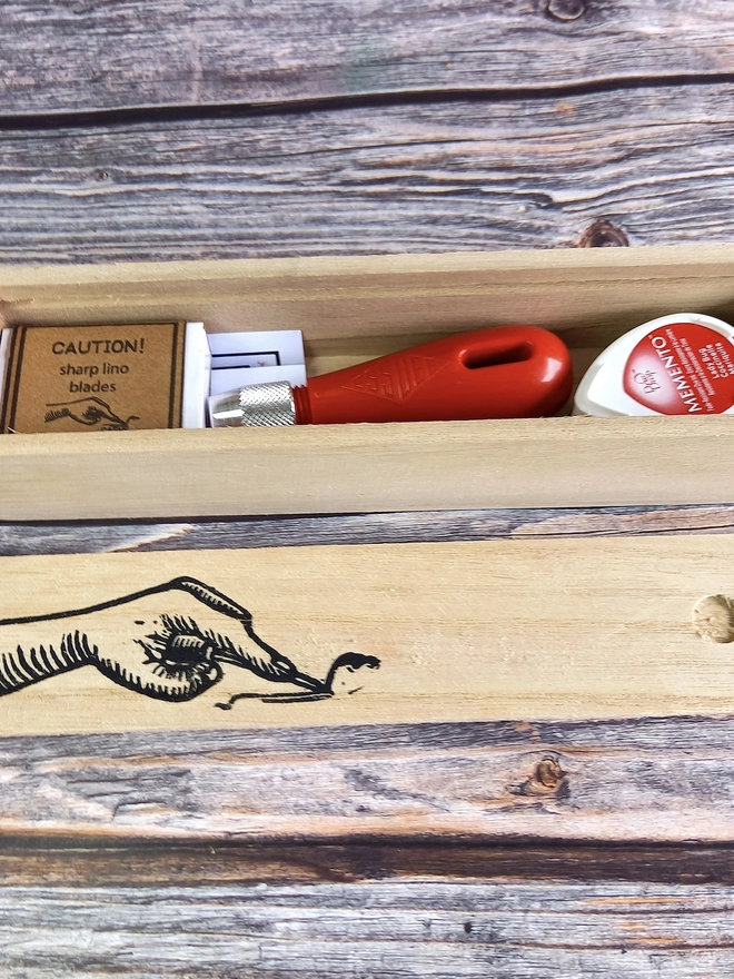 Lino Carving Printing Tool Kit In Presentation Box, packed together in a wooden box on a table. 