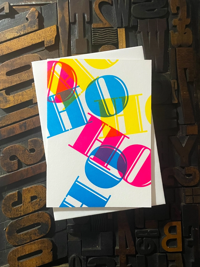 Ho Ho Ho! A beautiful typographic letterpress Christmas card. Printed with rich vibrant and fluorescent blue, magenta and yellow inks with luxury matching and contrasting envelopes; ideal to send to your designer friends at the festive season.