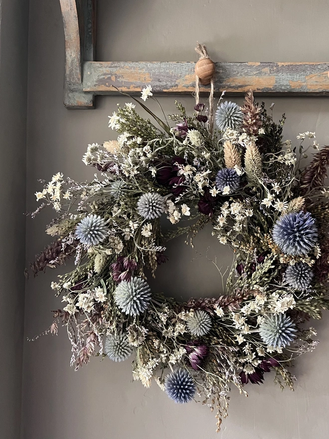 Dried Flower Winter Wreath hanging on kitchen wall 