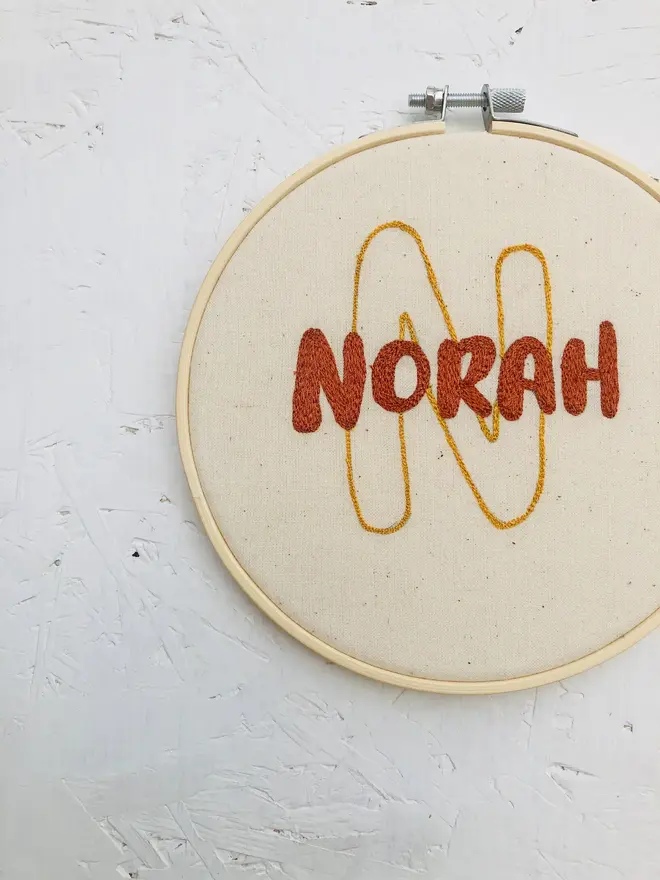 personalised name and initial embroidered hoop. cotton hoop embroidered with name nora and letter n.