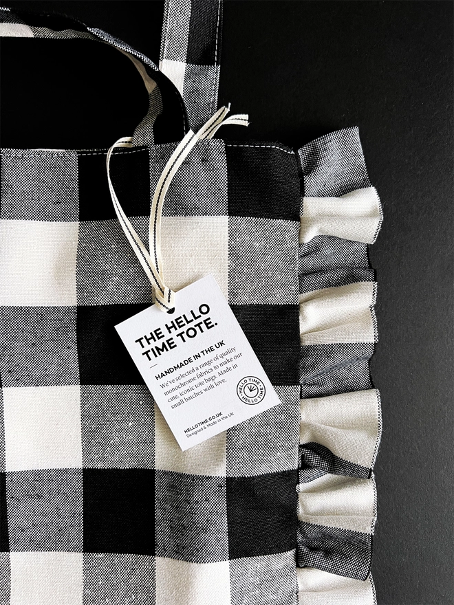 Close up of a black and white check cloth tote bag