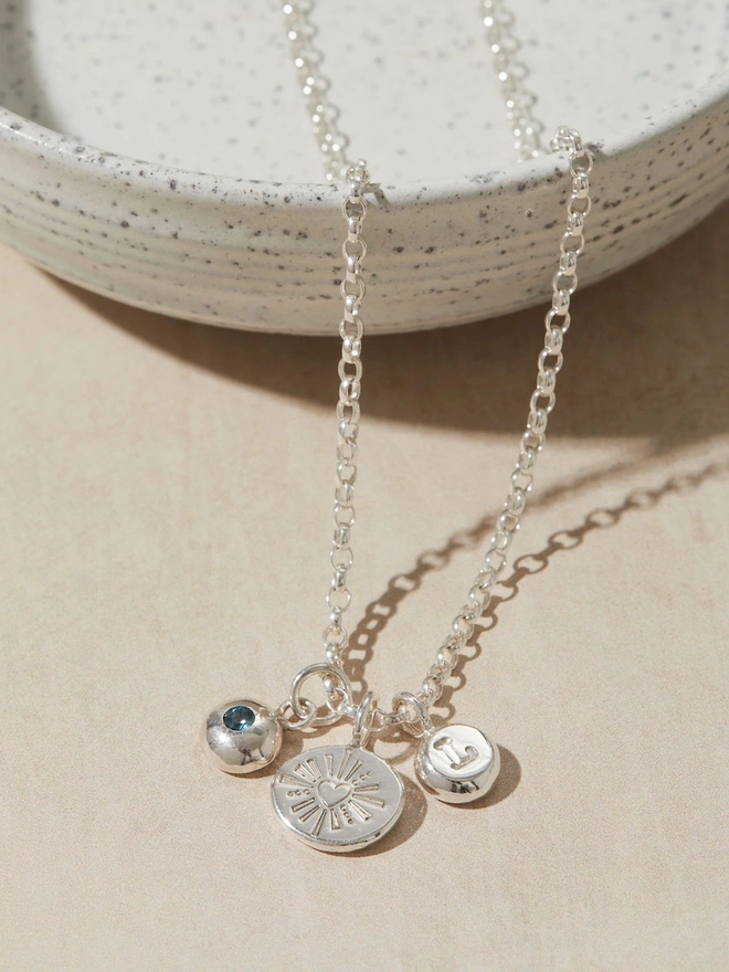 Silver Darling Heart Pebble Necklace close up image with two charms