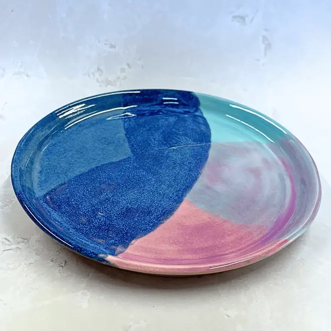 Landscape Dinner Plate, a colourful plate placed on a stone surface. 