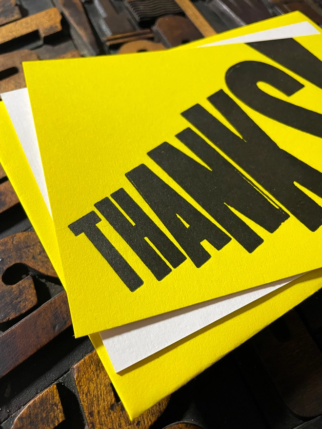 Thanks! A beautiful typographic letterpress postcard printed with rich black ink on thick vibrant yellow colourful card with a luxury matching envelope; ideal to send a thank you note to a friend or loved one.