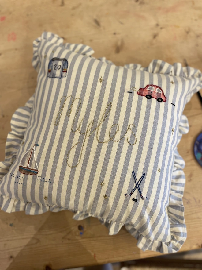 Blue stripe ruffle cushion with hand embroidered details. Personalised design 