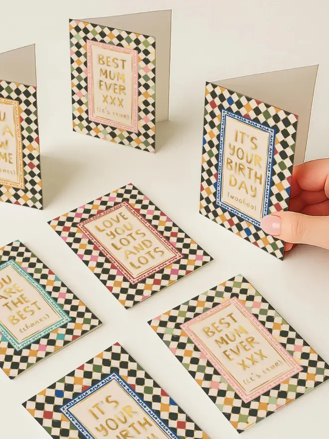 Checkerboard greeting cards on a white table. 