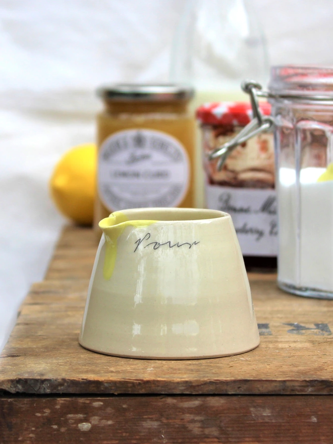 mini pour jug with baking ingredients behind