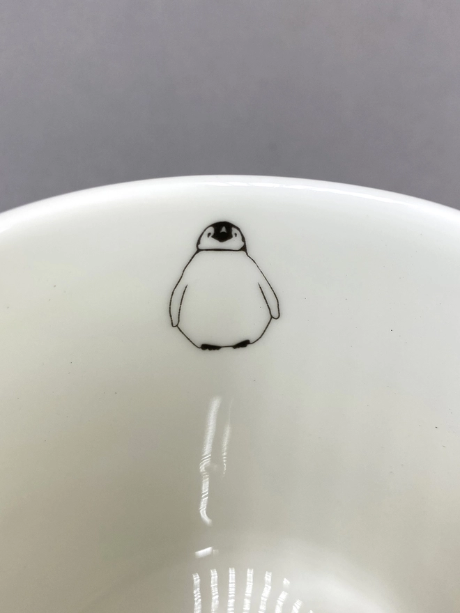 Close up of the very cute baby penguin on the inside of the multi penguin mug