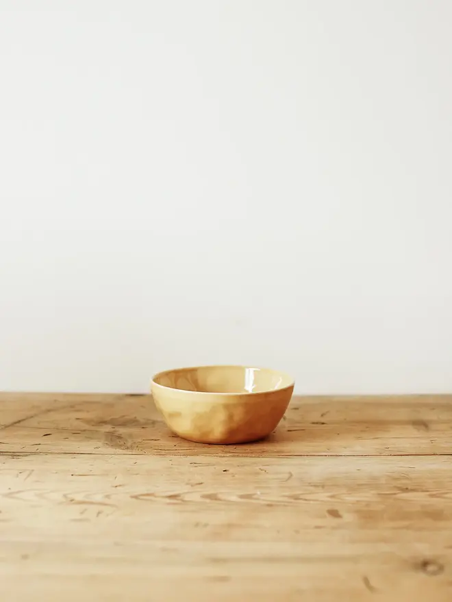 'dijon' handcrafted stoneware serving bowls. a small yellow serving bowl.