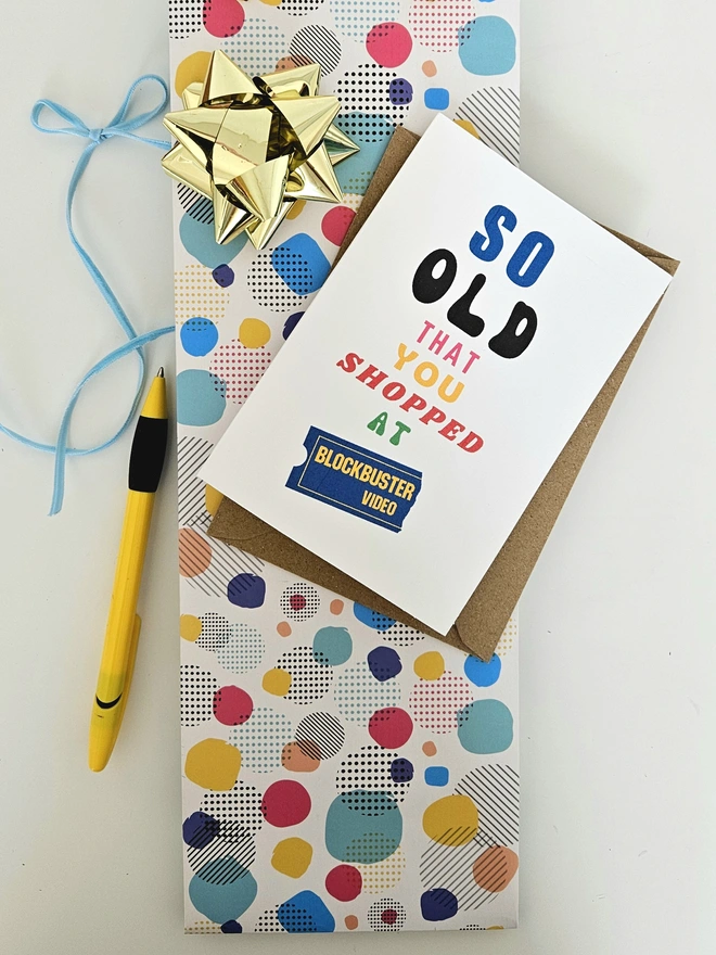A photograph of the front of a humorous A6 greeting card illustrated using brightly coloured text and the retro shop logo. The text says so old you shopped at Blockbuster