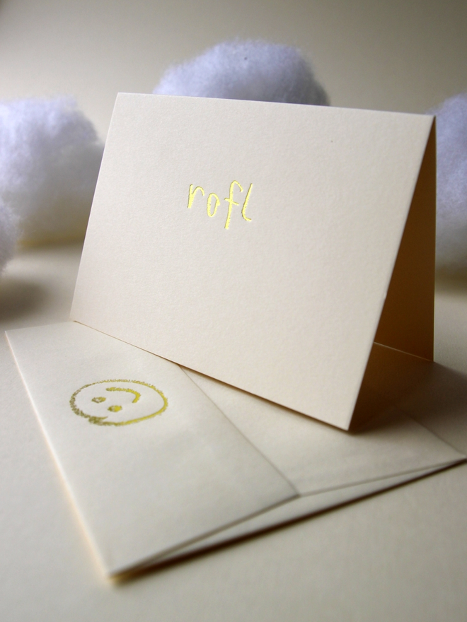 sandy coloured card with rofl short for 'roll on floor laughing' hand foiled in kids hand writing