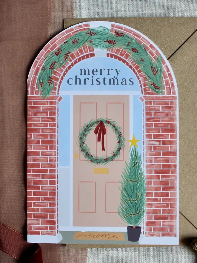 illustrated christmas door card. arch shaped card illustrated with christmas doorframe.