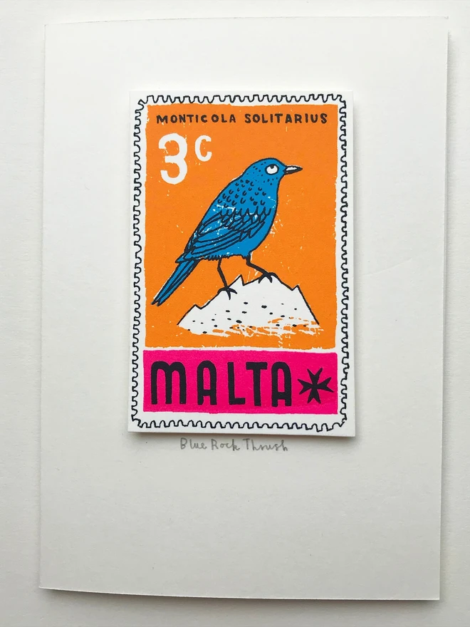 Bird Stamp Card Malta/ Blue Rock Thrush, a white card with a colourful bird design in the centre on top of a white backdrop. 