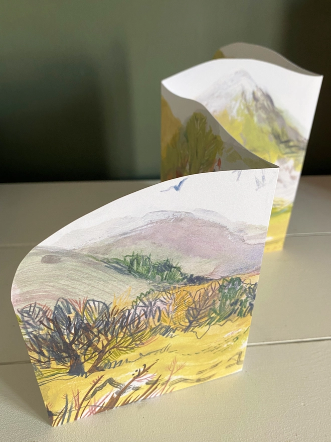 Esther kent illysrated and handcut greetings card, showing painted hilly landscape in greens and purple