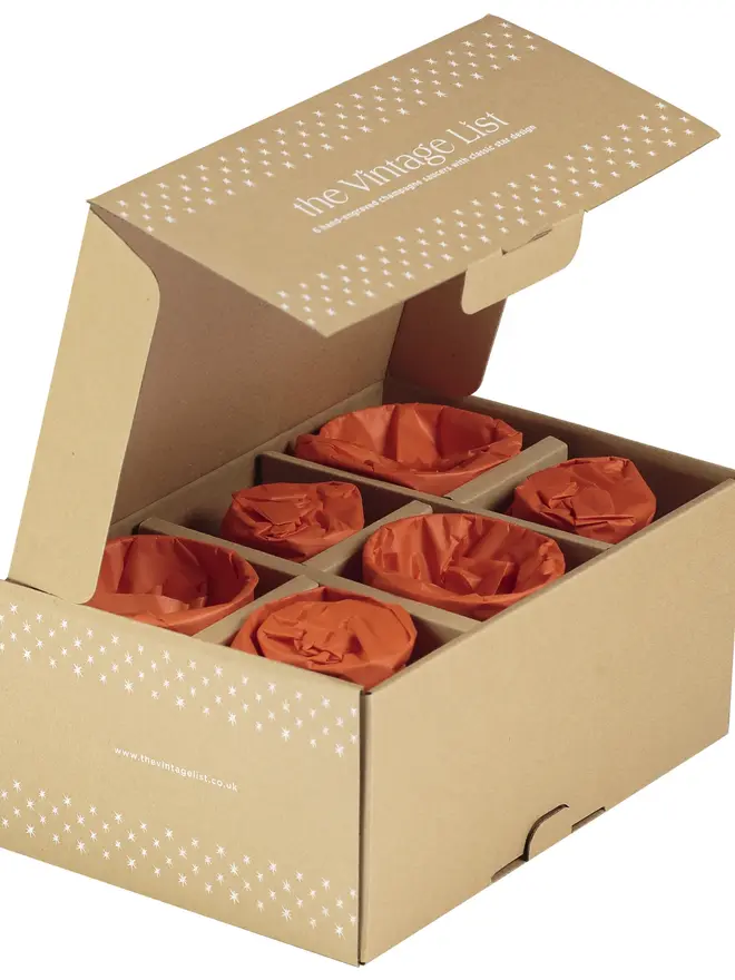 engraved ovals crystal champagne saucers. a cardboard box showing glass packaging.