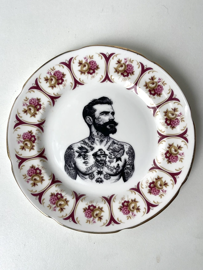a vintage plate with ornate border, within the centre i have printed the vintage style image of a victorian tattooed sailor man