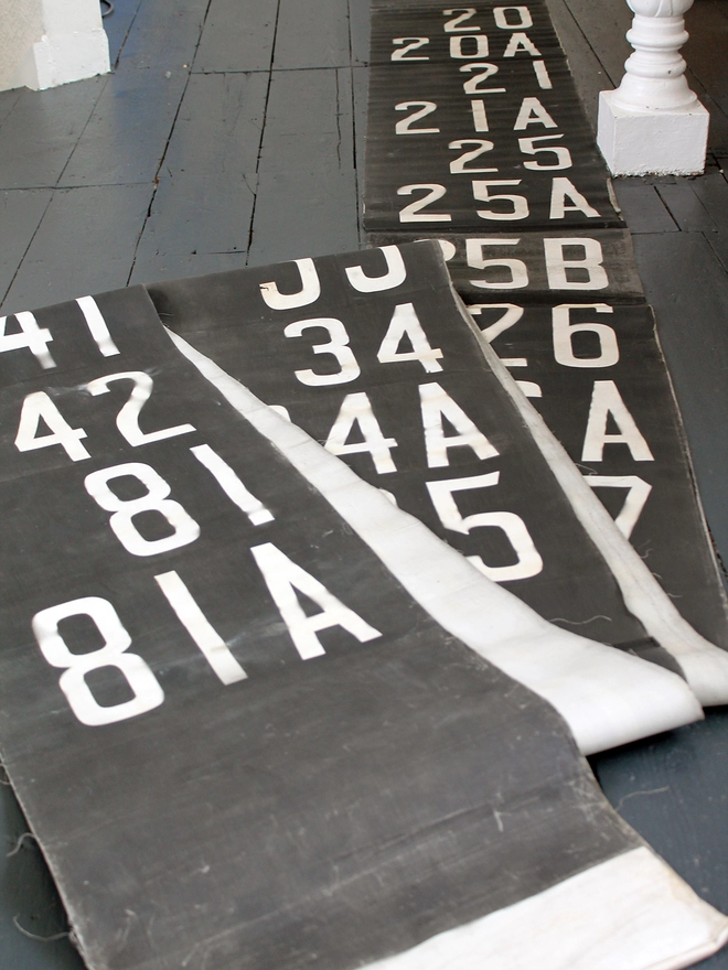 Roll of original bus destination blind laid out on floor