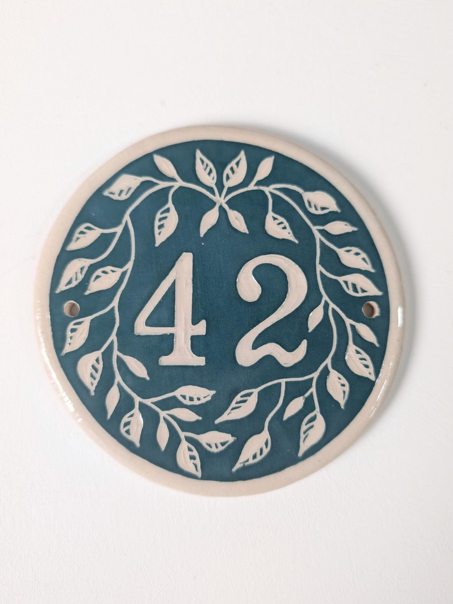 Custom Round Ceramic House Number with Leaves. A house number in mallard green.